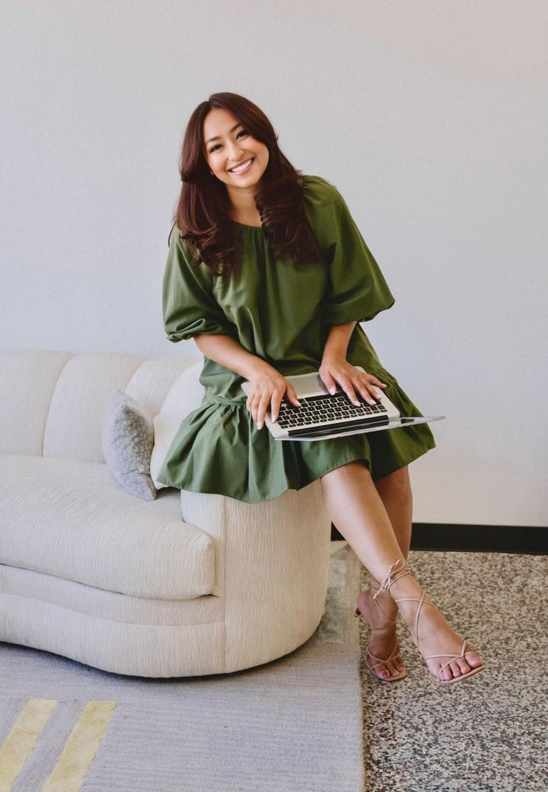 Paige Montgomery smiling with a laptop on her lap
